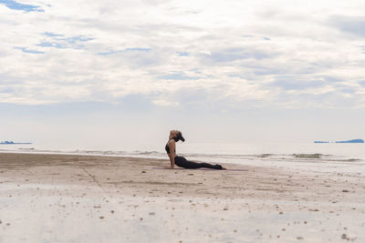 Full length of man on beach against sky