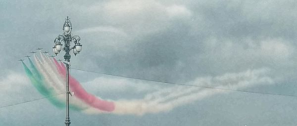 Low angle view of flags against sky