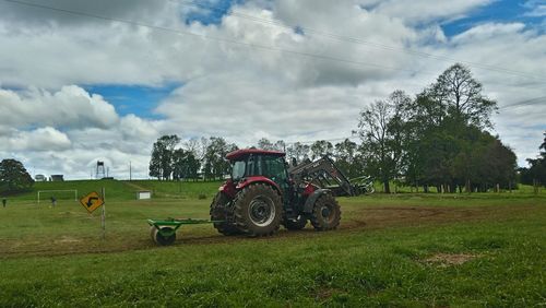 Tractor on field against sky