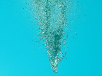 Close-up of water bubbles against blue background