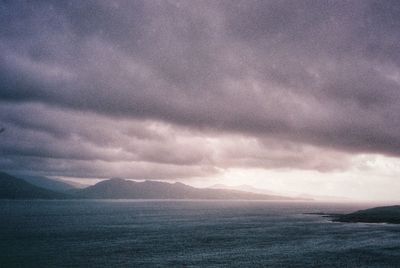 Scenic view of sea against storm clouds