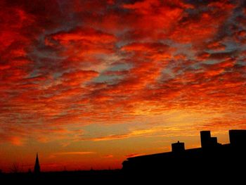 Silhouette of built structure against cloudy sky