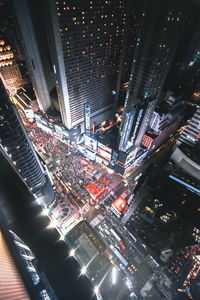 High angle view of illuminated buildings in city at night