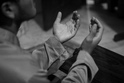 Midsection of man praying