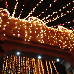Low angle view of illuminated lights at night