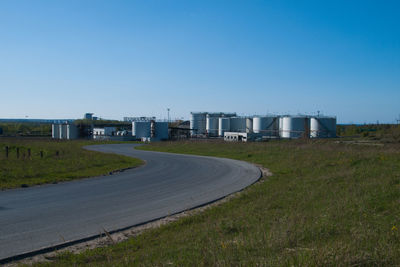 Road against clear blue sky