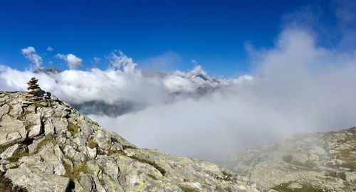 Panoramic view of mountains against blue sky