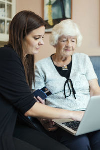 Young woman using mobile phone at home