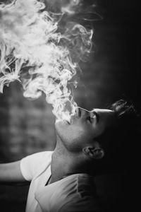 Close-up of young man smoking cigarette