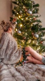 Midsection of woman holding christmas tree