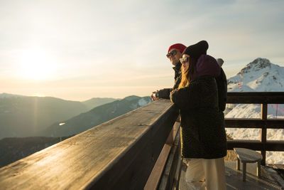 Couple enjoying winter sunny weather holiday ski resort outdoors. caucasian happy young people 