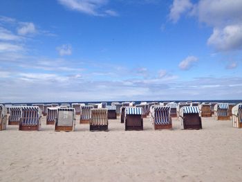 Scenic view of beach against cloudy sky