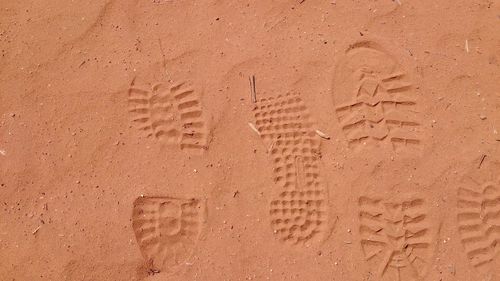 High angle view of footprints on sand