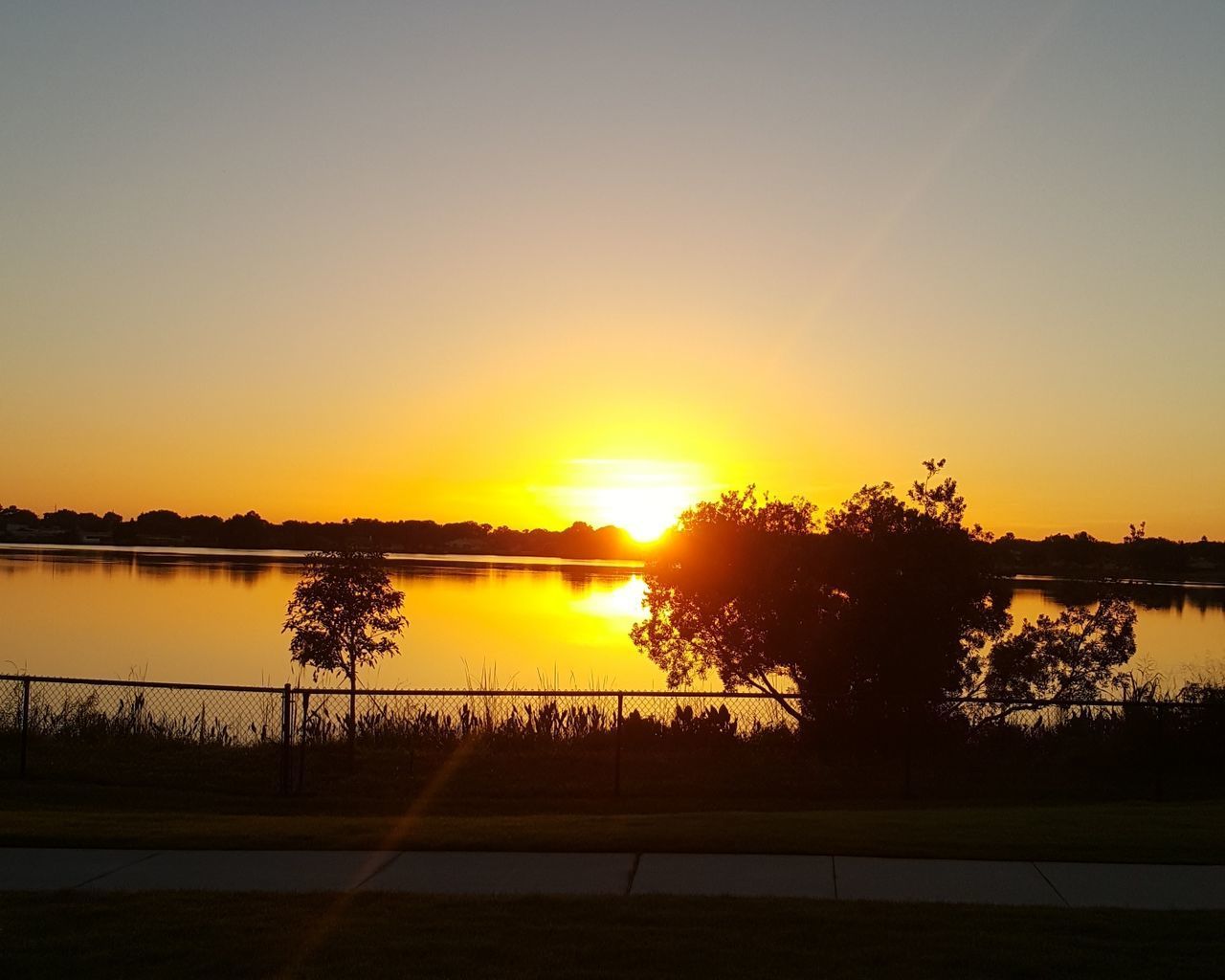 SCENIC VIEW OF SUNSET OVER LAKE