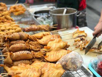 Person preparing food at market stall