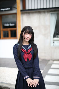 Portrait of beautiful young woman standing outdoors