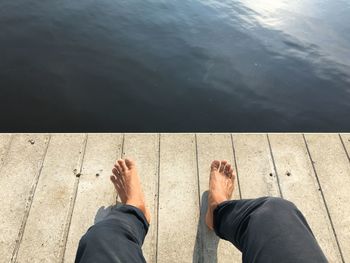 Low section of woman standing in water