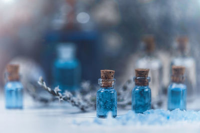 Close-up of liquid in bottles on table at spa