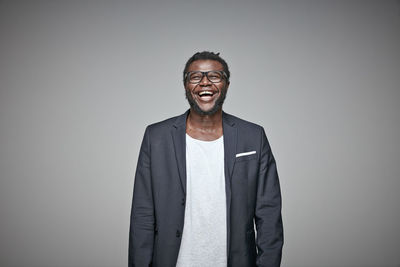 Portrait of laughing man wearing glasses and jacket