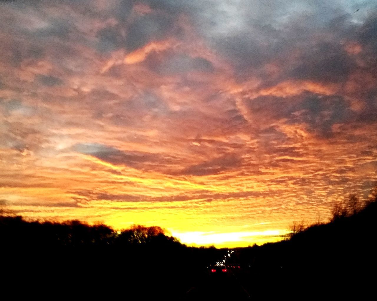 SCENIC VIEW OF DRAMATIC SKY OVER SILHOUETTE LANDSCAPE