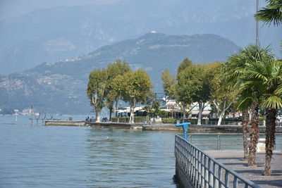 Scenic view of river and mountains against sky