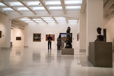 Rear view of people standing in museum