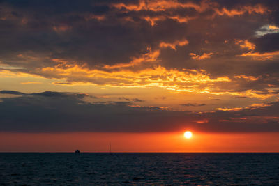 Scenic view of sea against orange sky