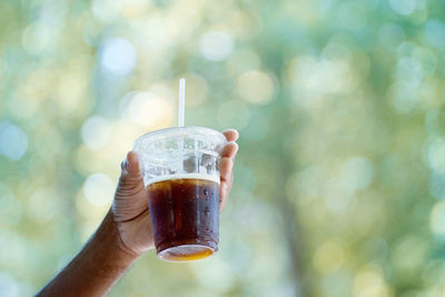 Close-up of hand holding drink