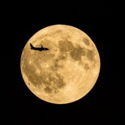 Low angle view of moon against sky at night