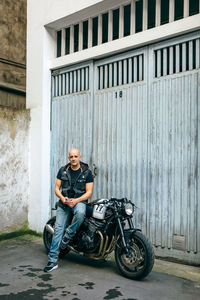 Full length portrait of man riding motorcycle