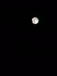 Low angle view of moon against dark sky