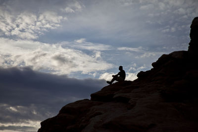 Low angle view of man standing on cliff