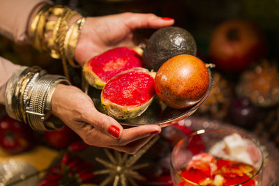 Midsection of woman holding fruits