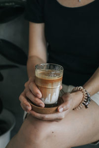 Midsection of woman holding drink