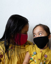 Asian young kids are wearing hygienic reusable face mask to prevent the virus. new normal.