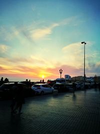 Boats in sea against sky during sunset