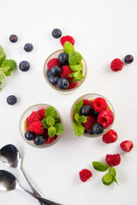 Directly above shot of strawberries on table against white background