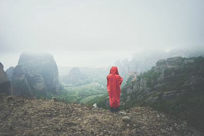 Rear view of woman on mountain against sky