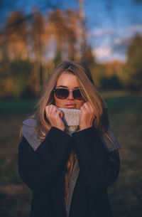 Beautiful woman standing in forest during autumn