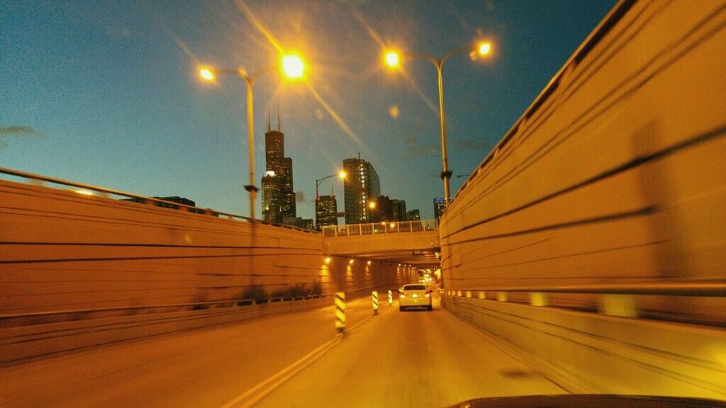 ILLUMINATED CITY AGAINST SKY AT NIGHT