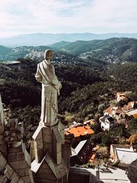 Statue of townscape against sky in city