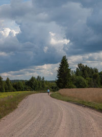 Tire tracks on road against sky