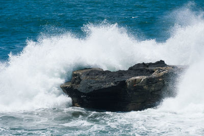 Waves breaking against sea