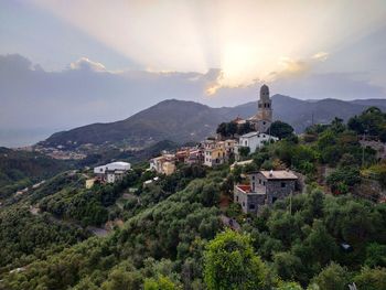 Townscape by mountains against sky
