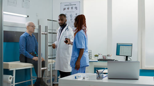 Portrait of young female doctor standing in laboratory