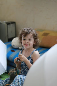 Portrait of smiling girl playing at home