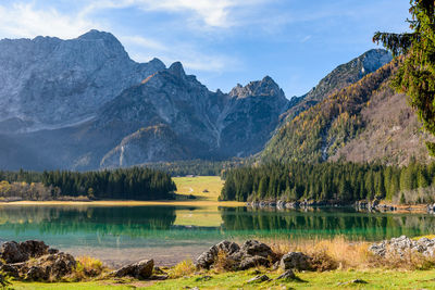 Amazing alpine lake under mountains on a sunny day in autumn