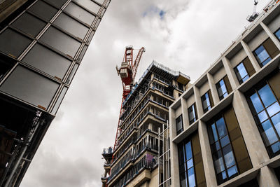 Low angle view of buildings against cloudy sky