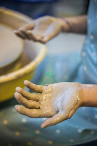Cropped hands of making pot