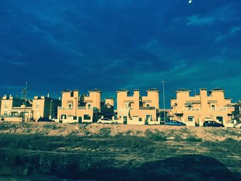 Buildings against cloudy sky